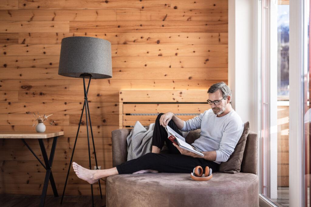 Outside, Swiss stone pine suite, man reading.