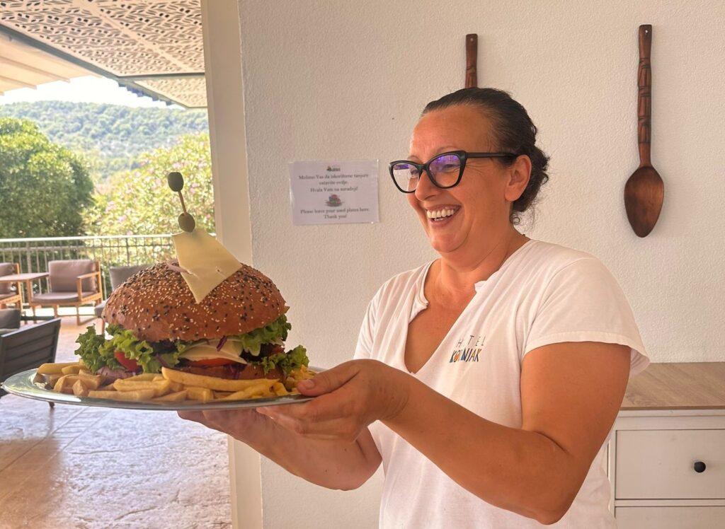 A woman presented a giant veggie burger at the Hotel Korinjak in Croatia.