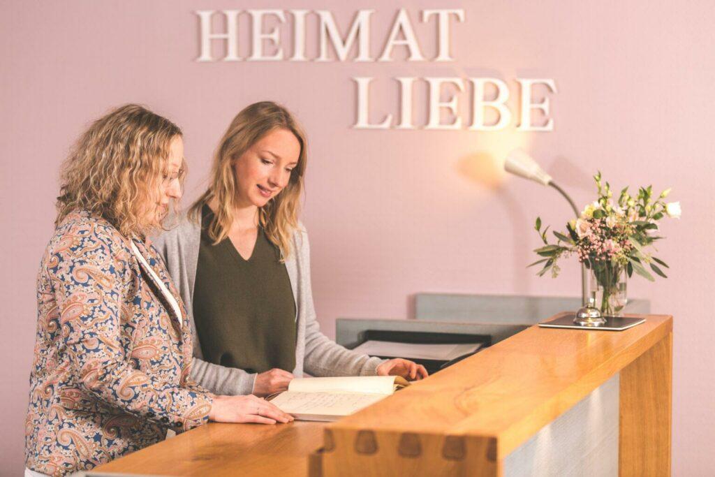 Maren and Kristin Okelmann at the reception of their sustainable family hotel