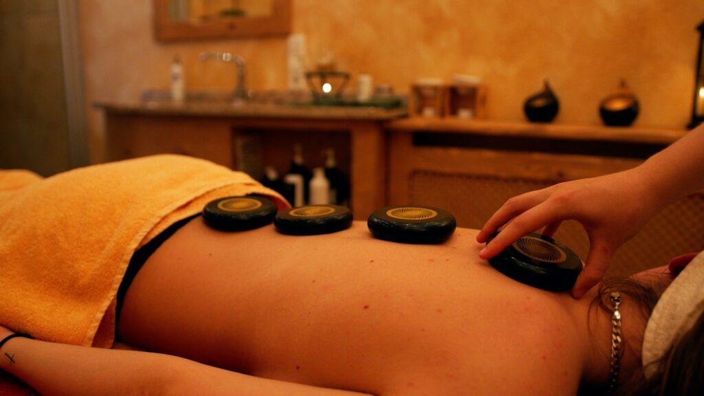 Stress relief massage with stones on a woman's back.