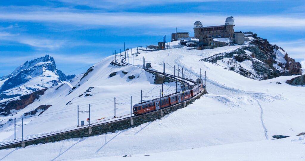 Environmentally friendly travel by train. With the Gronergrad mountain railroad through the snow in Switzerland.