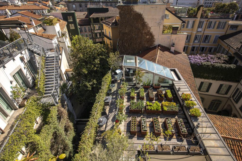 Aerial view of the roof terrace and herb garden of the sustainable Hotel Milano Scala in Milan, Italy.