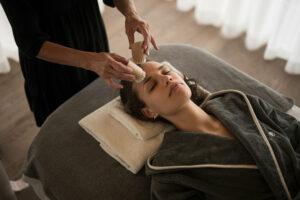 Young woman enjoys the signature treatment at the HUBERTUS Mountain Spring Spa