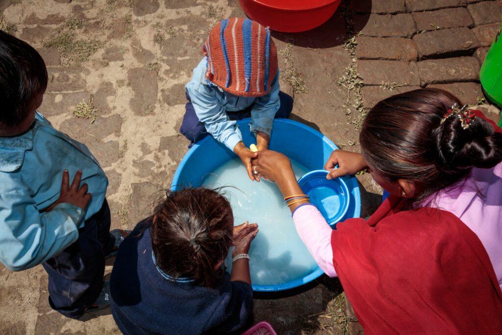 Nepalese children washing their hands before lunch