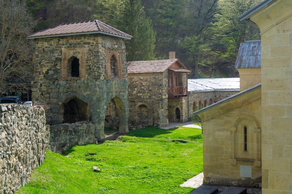 The yard of the Kvatakhevi Monastery. Stone walls, a tower, part of the church, monks' living quarters.