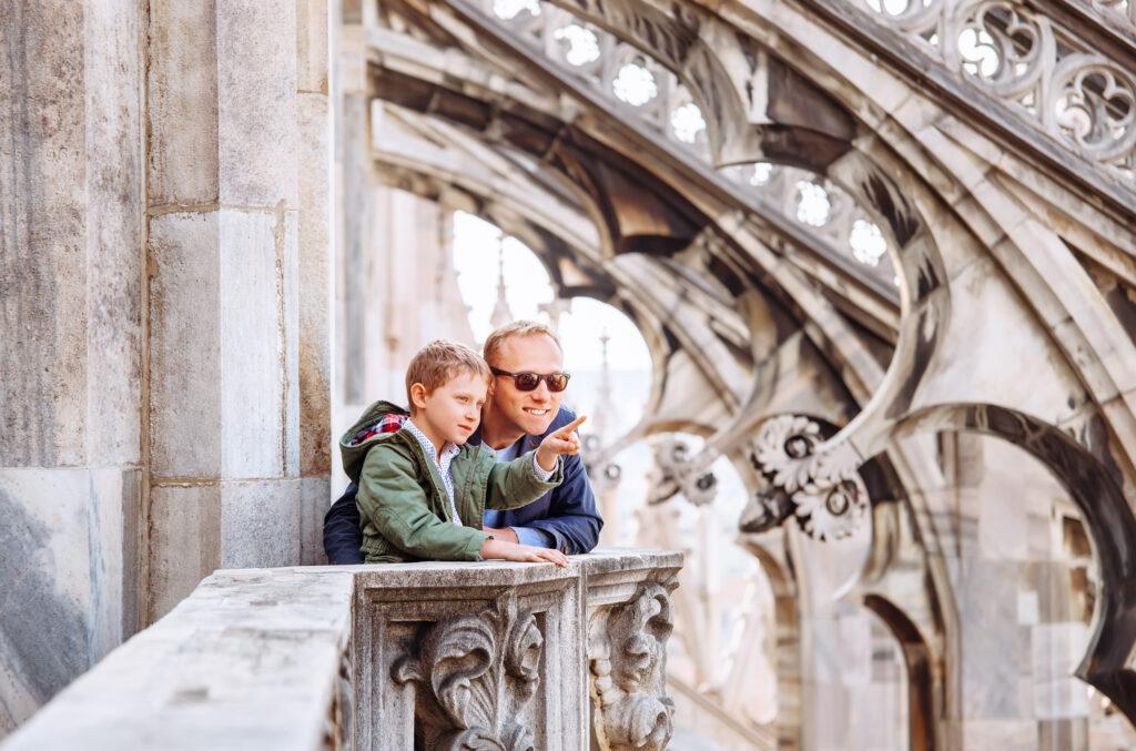 Sustainable travel in Milan. Father and son in the cathedral of Milan