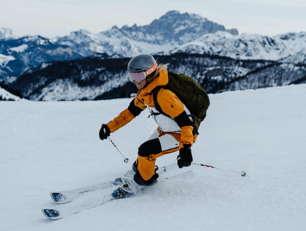 A young woman is skiing in the Dolomites.