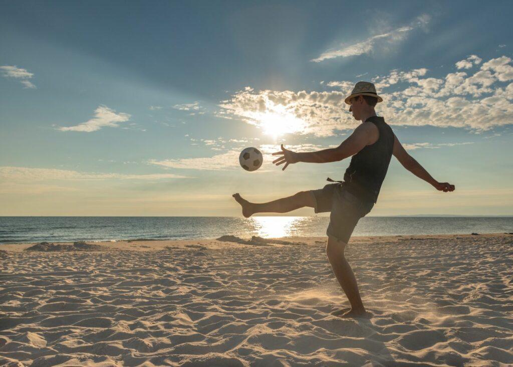 Man plays ball on the beach