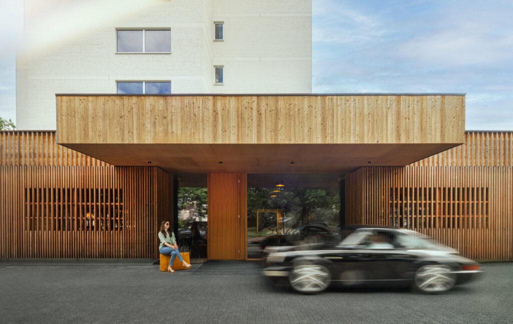 Exterior facade of STURM Hotel Mellrichstadt with Porsche and people