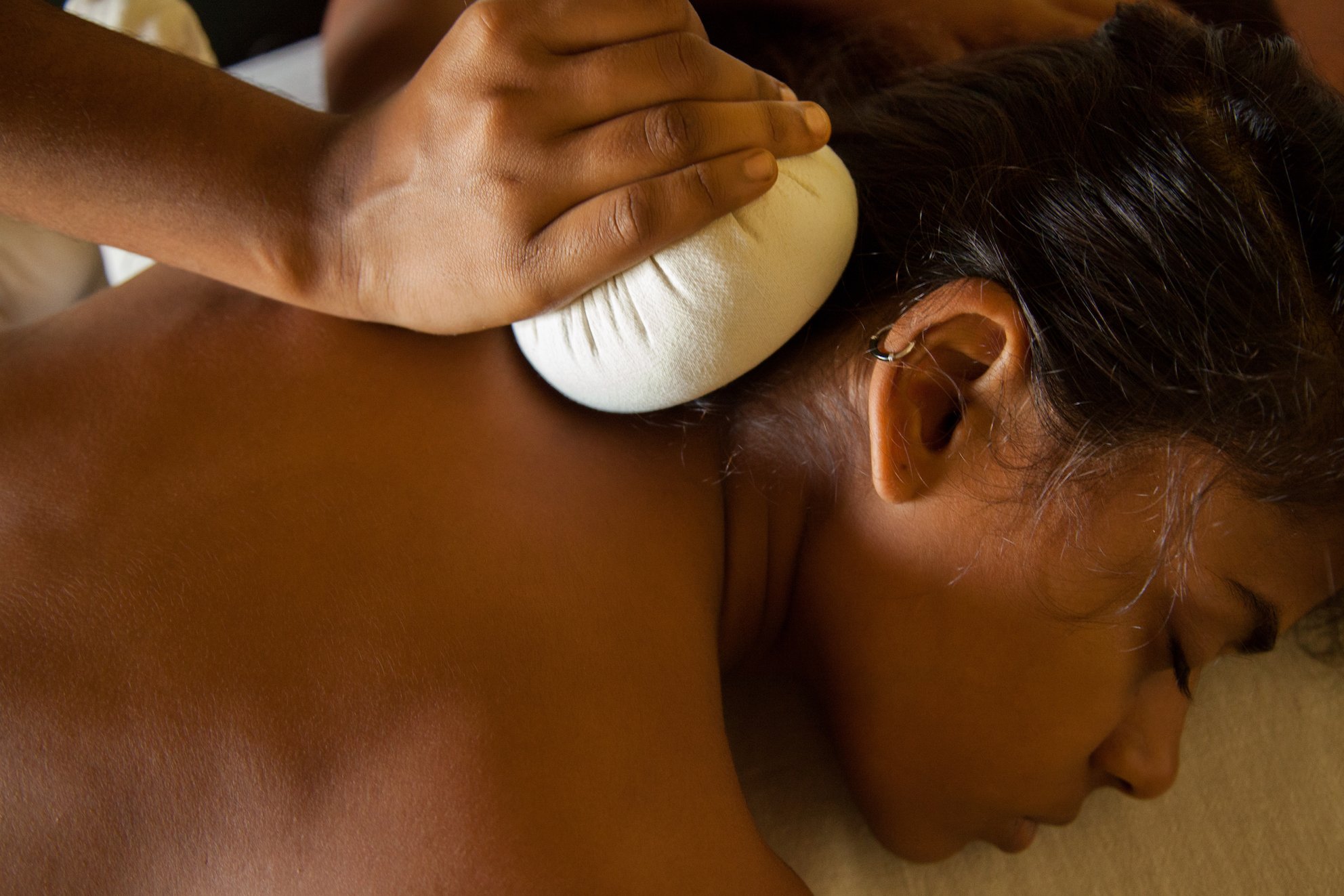 Relax during a massage with herbal essences in an Ayurvedic treatment at SwaSwara.