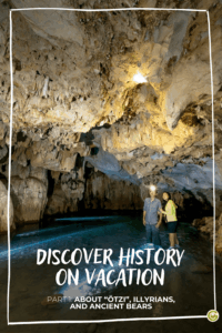 A couple explores a dimly lit cave with stunning stalactite formations. Text reads, "Discover History on Vacation: Ötzi, Illyrians, and Ancient Bears," creating a sense of adventure.