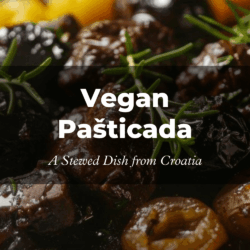 Close-up of a rich, dark vegan pašticada stew with olives, yellow peppers, and rosemary. Overlay text: "Vegan Pašticada - A Stewed Dish from Croatia."