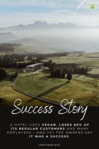 Aerial view of the hotel Paradiso Pure.Living Vegan Hotel surrounded by lush green fields and the Dolomites in the background under a blue sky. Text overlay reads "Success Story" about a vegan hotel.