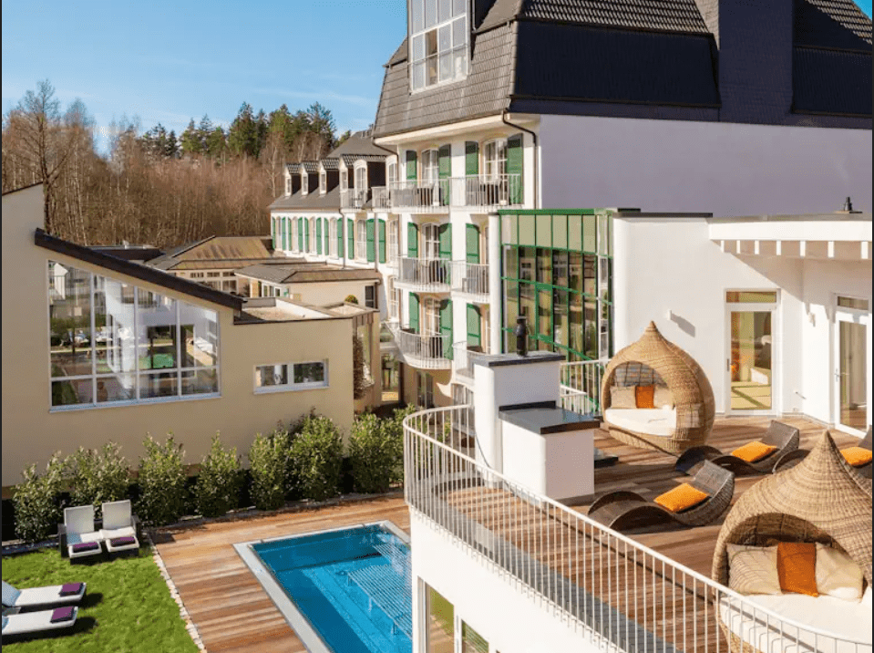 Exterior view of the Lifestyle Resort Zum Kurfürsten with sunshine, pool and terrace.